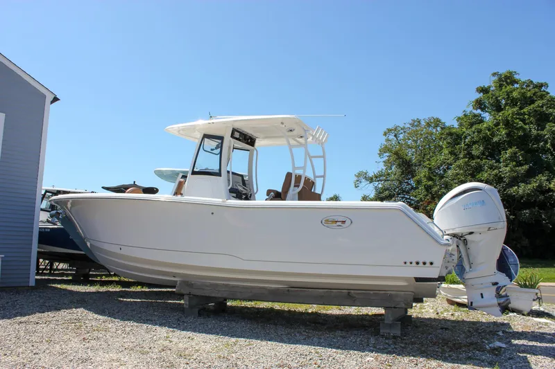 Slide: The Image of 2025 Sea Hunt Gamefish 28 Forward Seating boat on display outdoors. - 3