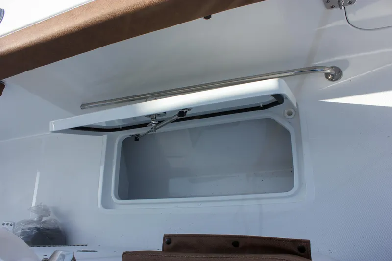 Slide: The Image of 2025 Sea Hunt Gamefish 28 Forward Seating storage compartment with open hatch. - 33