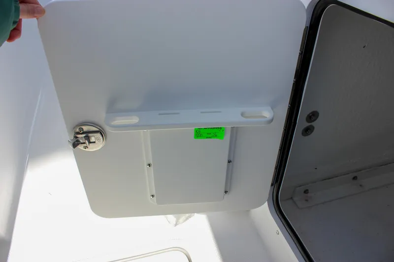 Slide: The Image of 2025 Sea Hunt Gamefish 28 Forward Seating storage compartment with latch and open door. - 35