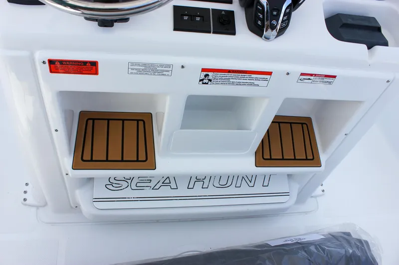 Slide: The Image of 2025 Sea Hunt Gamefish 28 Forward Seating console with teak steps and controls. - 36