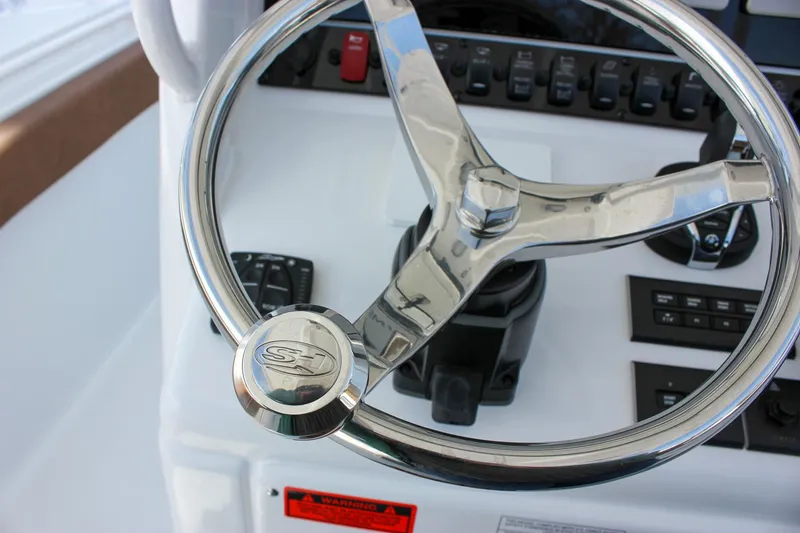 Slide: The Image of Steering wheel of 2025 Sea Hunt Gamefish 28 Forward Seating boat, showcasing controls. - 37
