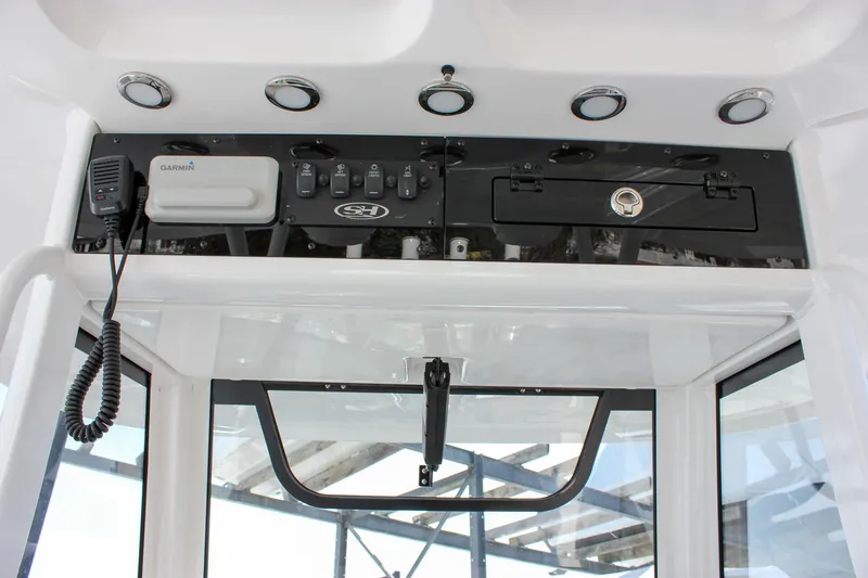 Slide: The Image of 2025 Sea Hunt Gamefish 28 console with electronics and controls. - 38