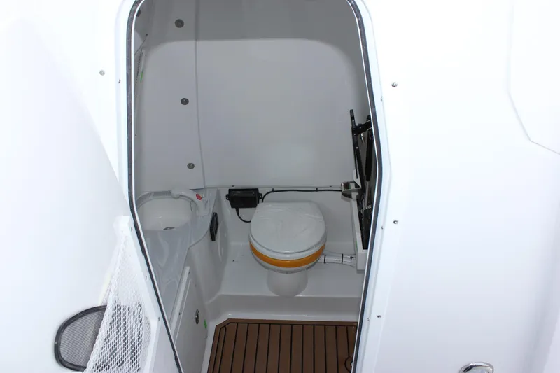 Slide: The Image of 2025 Sea Hunt Gamefish 28 Forward Seating boat interior with compact marine toilet. - 43