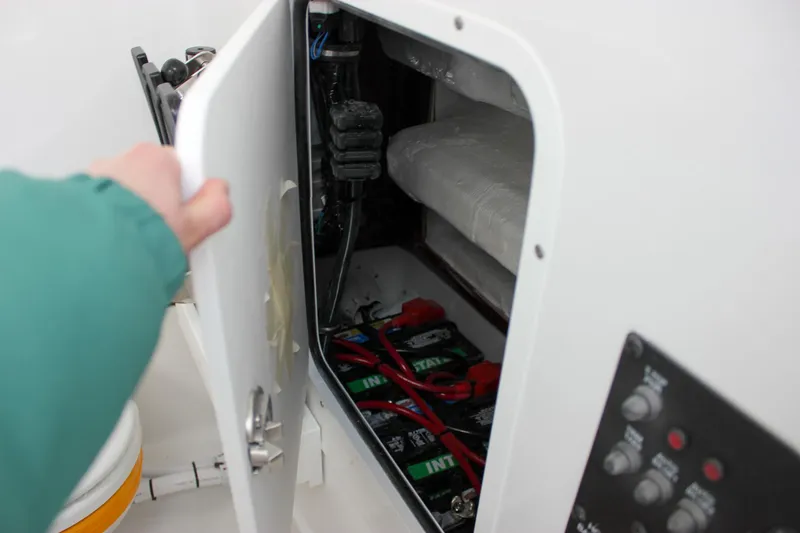 Slide: The Image of 2025 Sea Hunt Gamefish 28 battery compartment with wiring and control panel. - 44