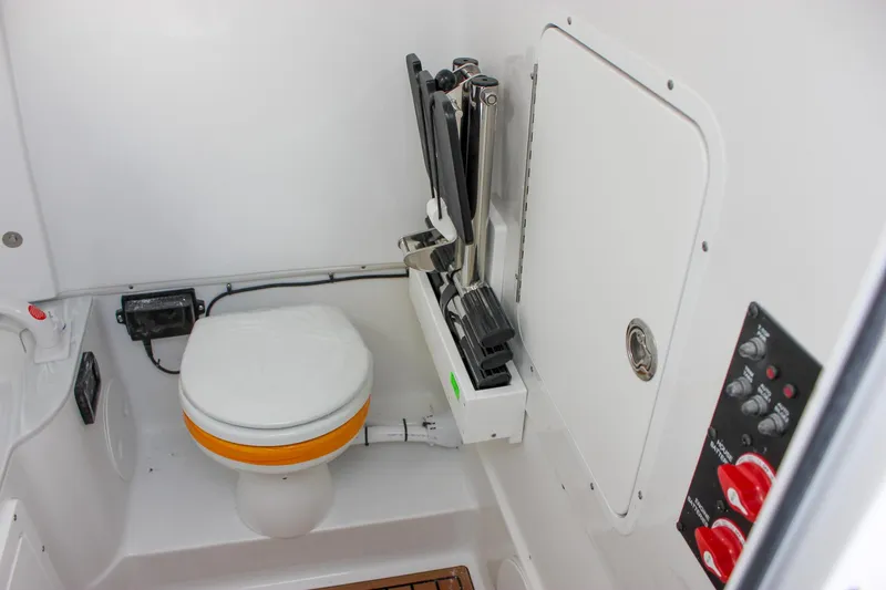 Slide: The Image of 2025 Sea Hunt Gamefish 28 Forward Seating boat interior with compact marine toilet. - 45