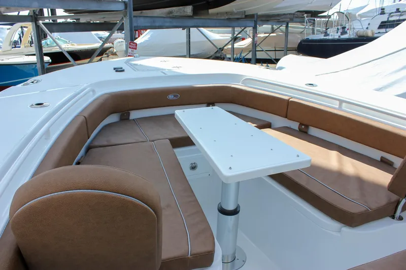 Slide: The Image of 2025 Sea Hunt Gamefish 28 Forward Seating with brown cushions and white table. - 49