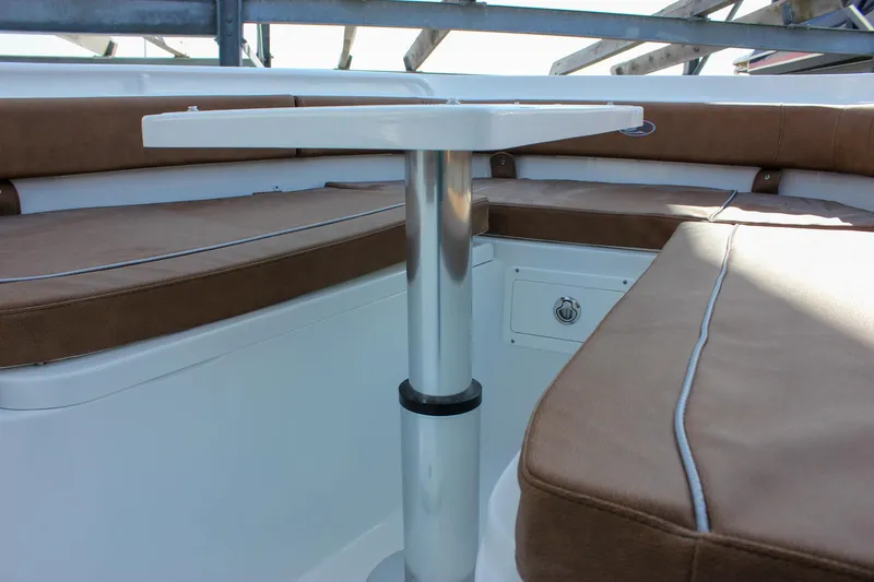 Slide: The Image of 2025 Sea Hunt Gamefish 28 Forward Seating with brown cushions and a central table. - 50