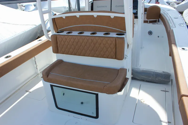 Slide: The Image of 2025 Sea Hunt Gamefish 28 Forward Seating, featuring tan cushioned seating and rod holders. - 7