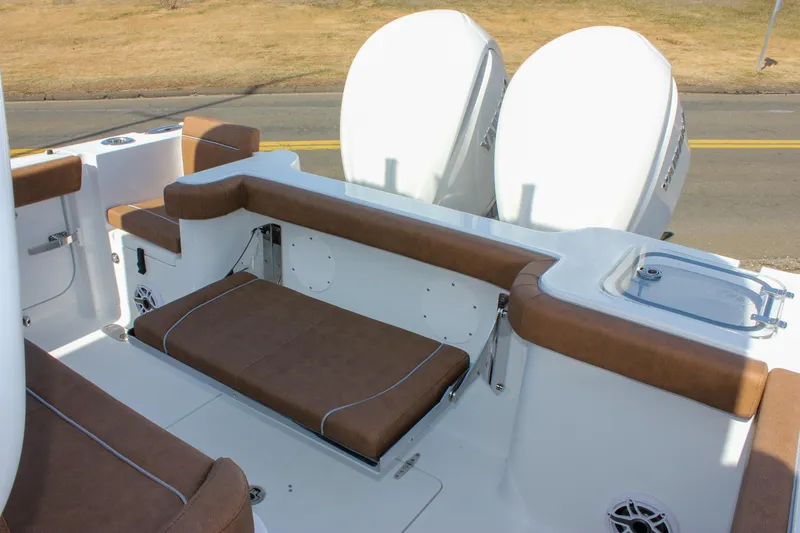 Slide: The Image of 2025 Sea Hunt Gamefish 28 Forward Seating with brown cushioned seats and dual engines. - 8