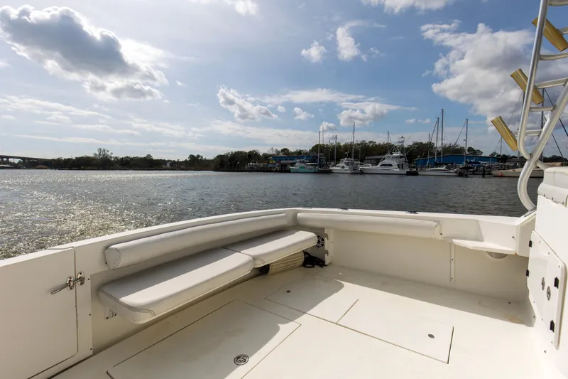 Slide: The Image of 2004 Wellcraft 330 Coastal boat deck with marina view under a partly cloudy sky. - 21