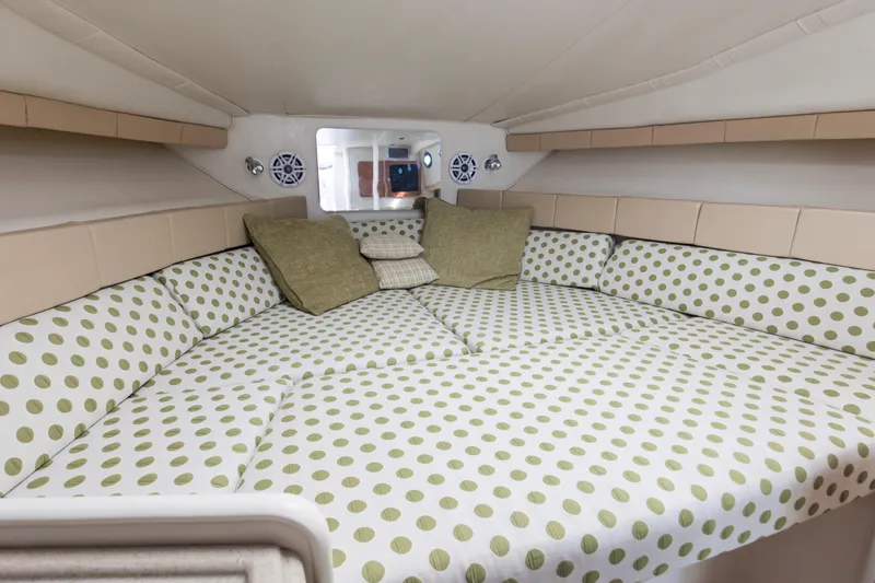 Slide: The Image of 2004 Wellcraft 330 Coastal cabin interior with polka dot bedding and cushions. - 32