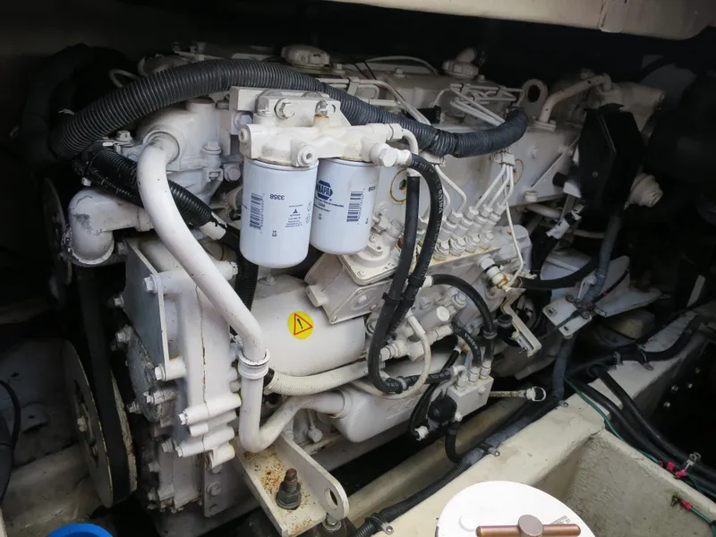 Slide: The Image of Engine compartment of a 2004 Wellcraft 330 Coastal boat, showcasing mechanical components. - 38