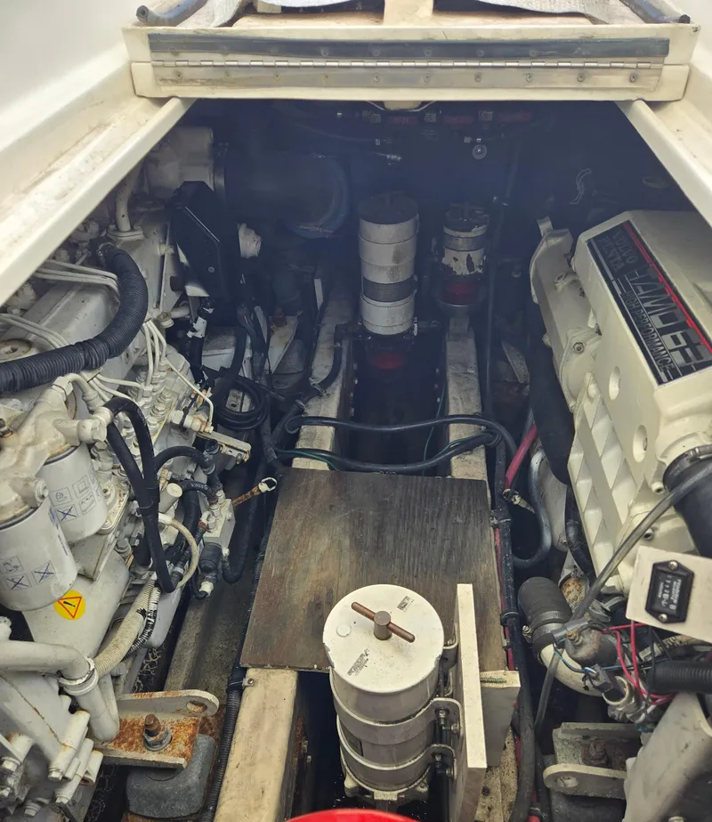 Slide: The Image of Engine compartment of a 2004 Wellcraft 330 Coastal boat, showcasing mechanical components and layout. - 39