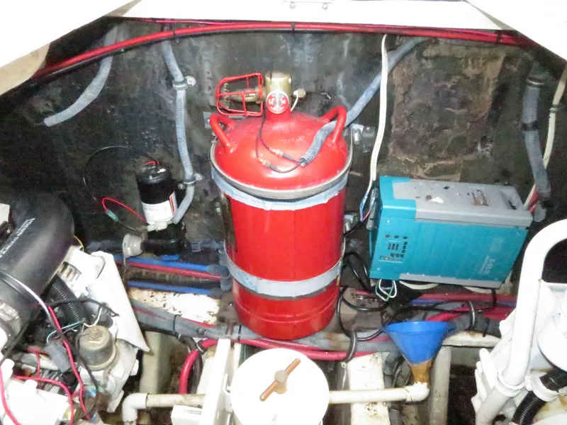 Slide: The Image of Engine compartment of a 2004 Wellcraft 330 Coastal with fire extinguisher and electrical components. - 40