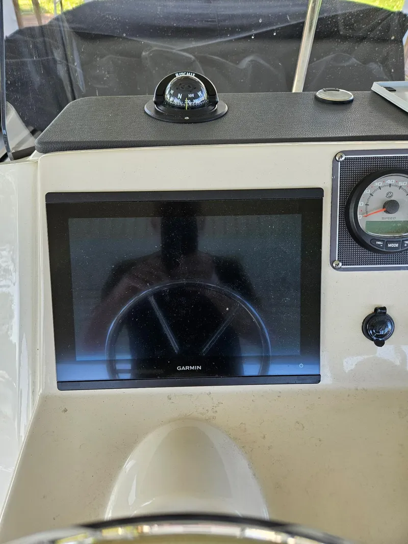 Slide: The Image of 2022 Boston Whaler 210 Montauk boat console with steering wheel and navigation system. - 16