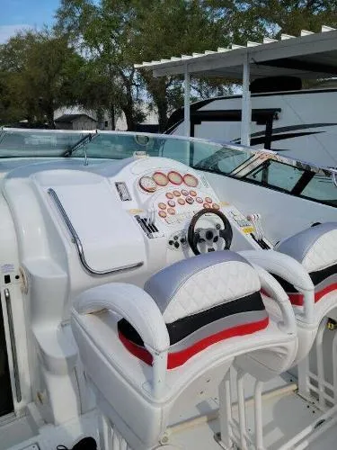 Slide: The Image of Cockpit of a 2000 Baja 442 boat with dual seats and control panel. - 14