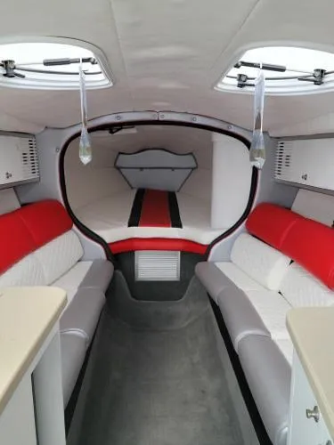 Slide: The Image of Interior of a 2000 Baja 442 boat with red and white seating. - 3