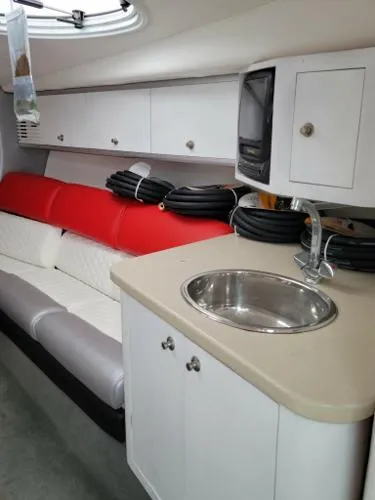 Slide: The Image of Interior of a 2000 Baja 442 boat with sink, seating, and storage cabinets. - 5