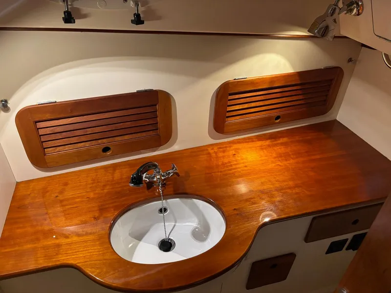 Slide: The Image of Hinckley Picnic Boat 36 (2002) interior with wooden countertop and sink. - 13