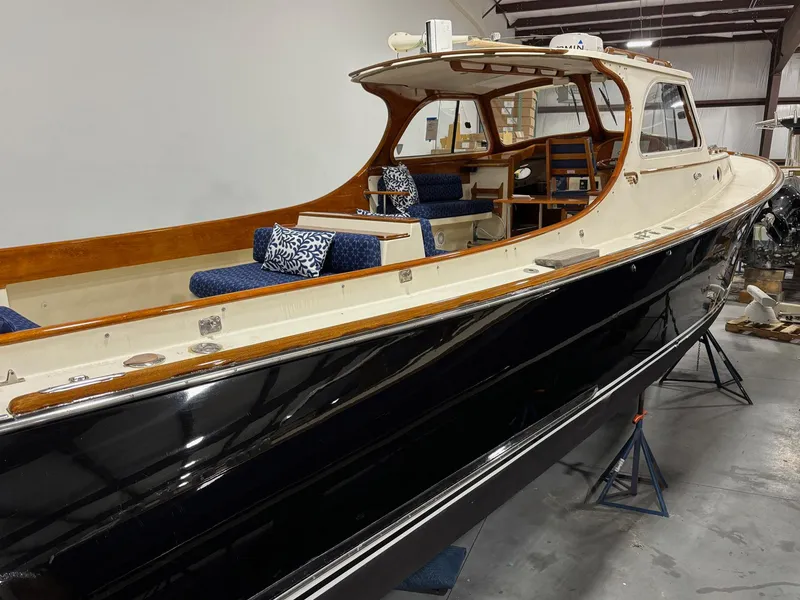 Slide: The Image of 2002 Hinckley Picnic Boat 36 with elegant wood accents and spacious seating. - 2