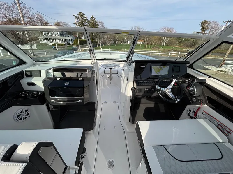Slide: The Image of 2025 Blackfin 272 DC boat interior with modern helm, seating, and navigation equipment. - 13
