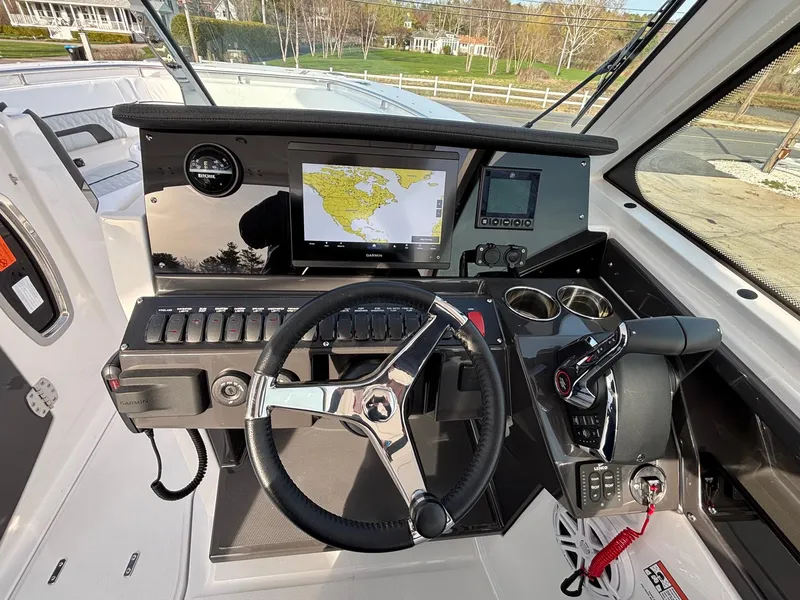 Slide: The Image of 2025 Blackfin 272 DC boat dashboard with navigation screen and steering wheel. - 14