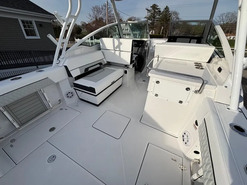 Slide: The Image of 2025 Blackfin 272 DC boat interior with white seating and modern design. - 17