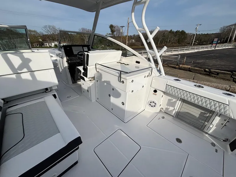 Slide: The Image of 2025 Blackfin 272 DC boat interior with seating, helm, and storage compartments. - 18