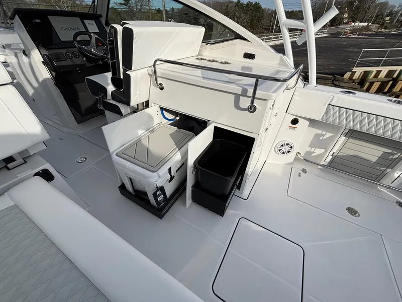 Slide: The Image of 2025 Blackfin 272 DC boat interior with seating, storage, and helm controls. - 19