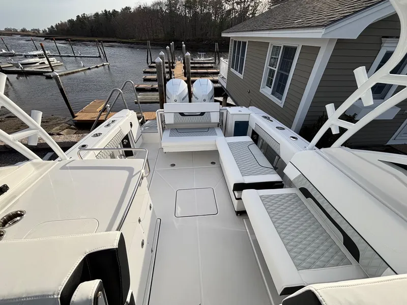Slide: The Image of 2025 Blackfin 272 DC boat interior with seating, docked at marina. - 22