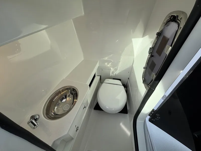 Slide: The Image of 2025 Blackfin 272 DC boat interior with compact bathroom and stainless steel sink. - 24