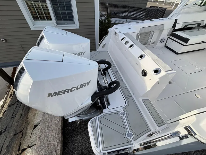 Slide: The Image of 2025 Blackfin 272 DC boat with dual Mercury outboard engines, sleek deck design. - 27
