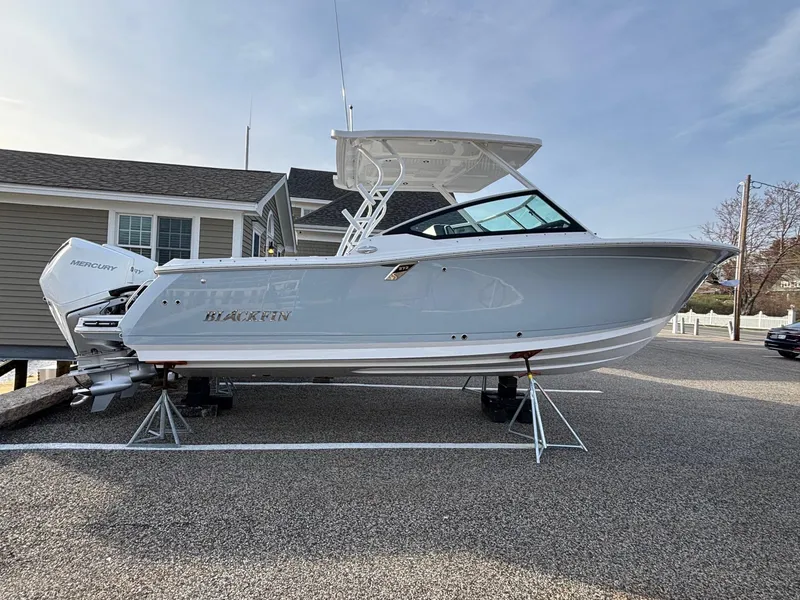 Slide: The Image of 2025 Blackfin 272 DC boat on display, featuring sleek design and dual engines. - 4
