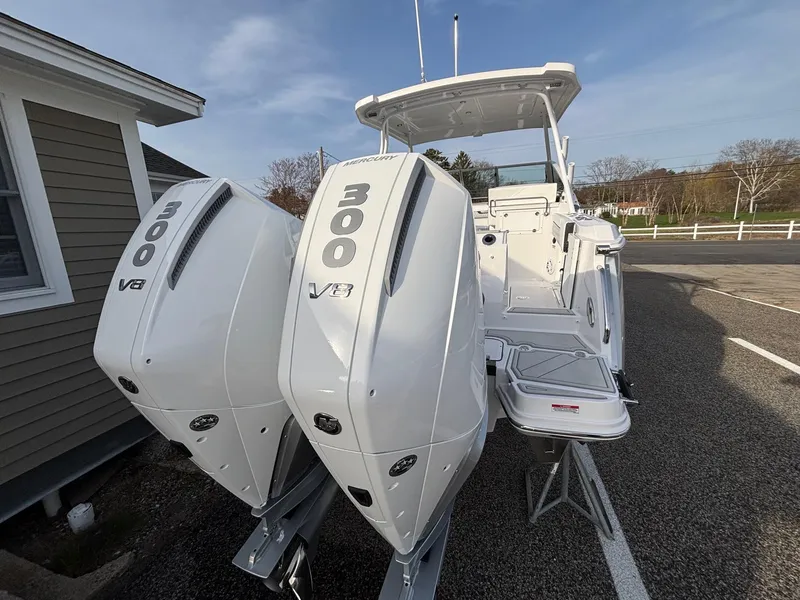 Slide: The Image of 2025 Blackfin 272 DC boat with dual 300 V8 engines, docked outdoors. - 8