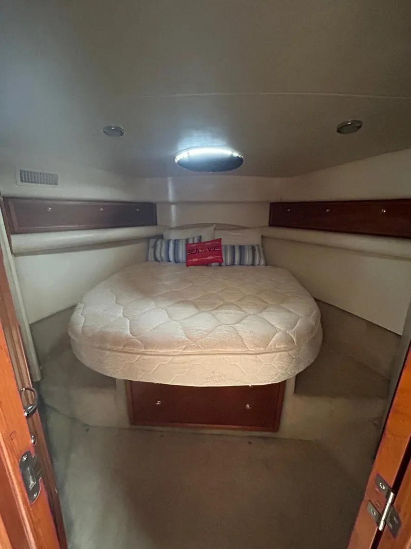 Slide: The Image of 2004 Riviera 40 yacht cabin with a cozy bed and ambient lighting. - 10