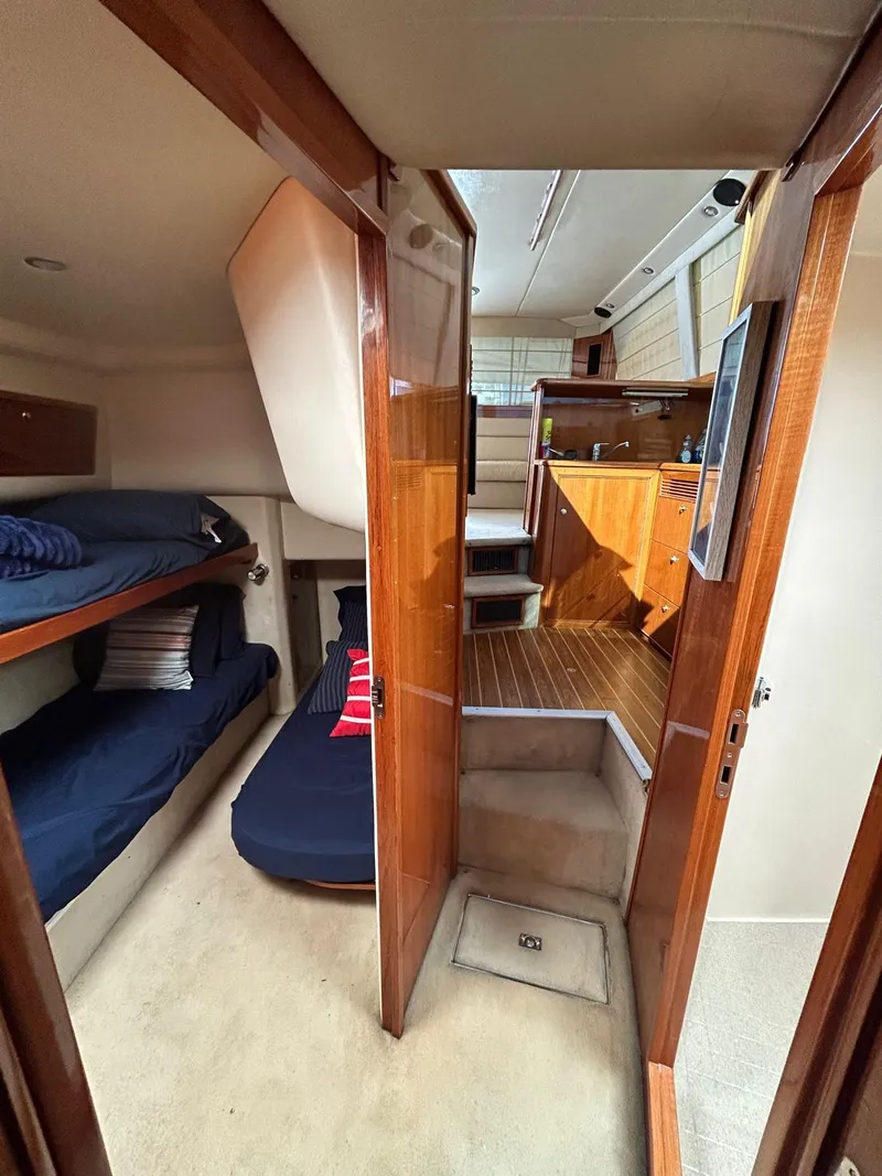 Slide: The Image of Interior of 2004 Riviera 40 yacht with cozy cabin and wooden finishes. - 11
