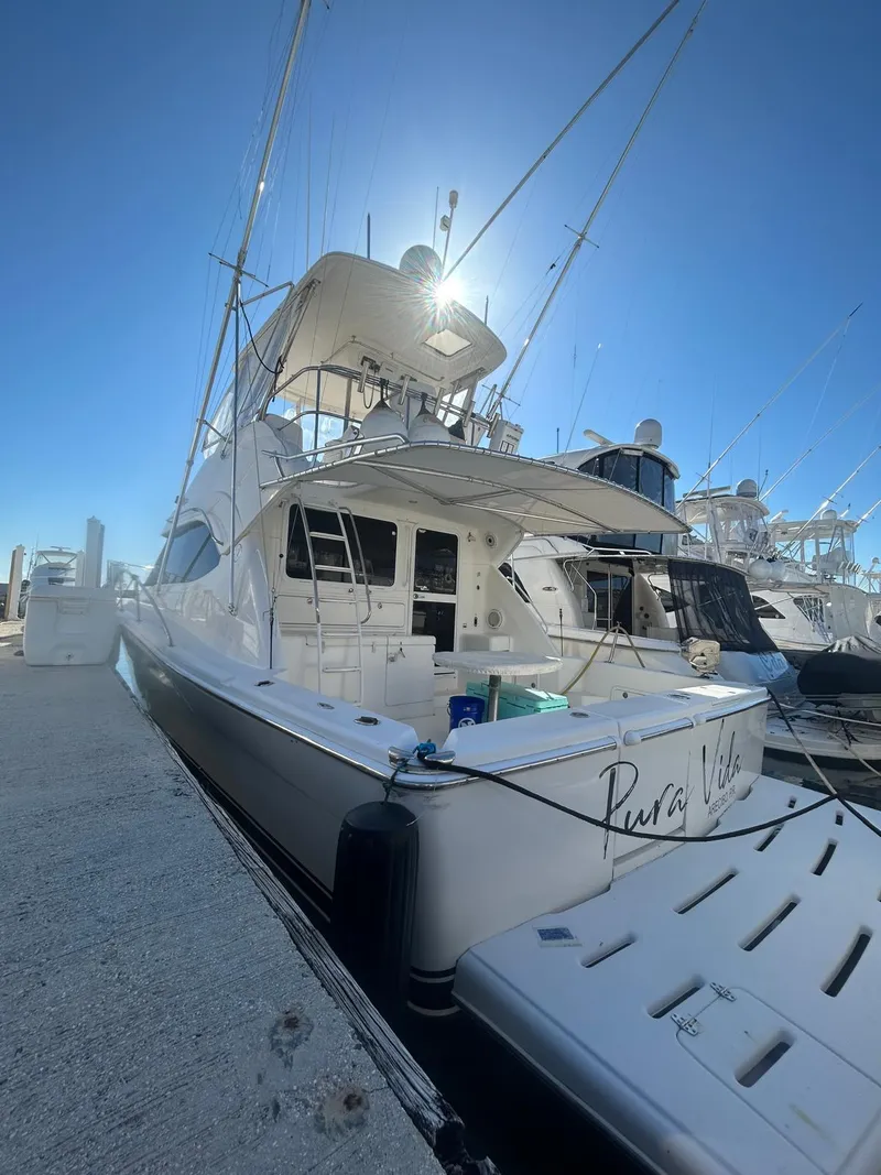 Slide: The Image of 2004 Riviera 40 yacht docked under clear blue sky. - 12
