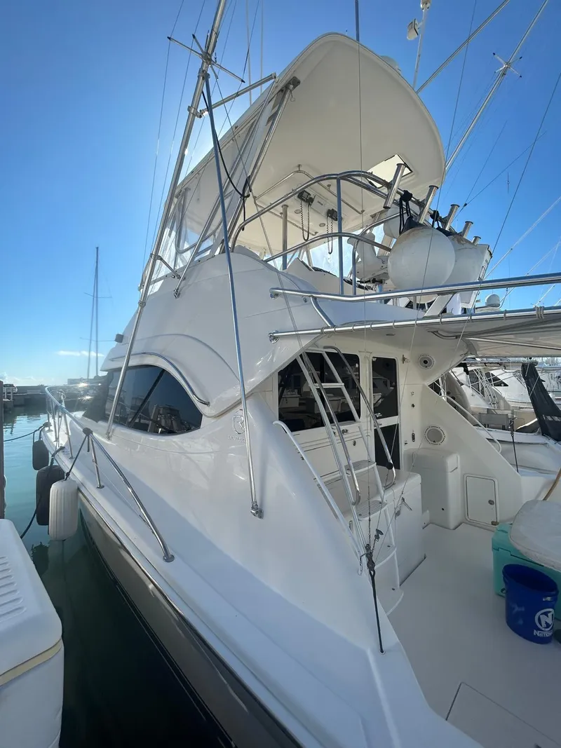 Slide: The Image of 2004 Riviera 40 yacht docked at marina under clear blue sky. - 13