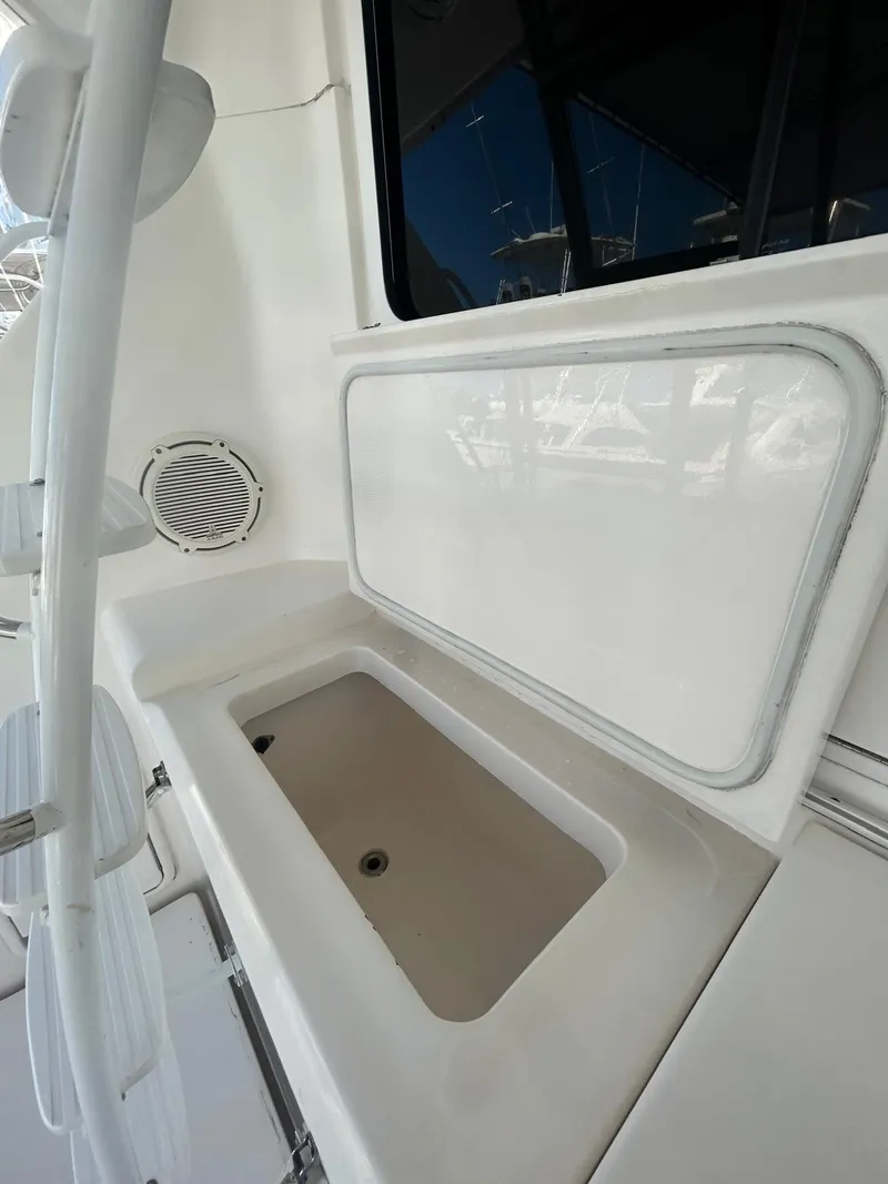 Slide: The Image of 2004 Riviera 40 boat interior with storage compartment and speaker. - 14