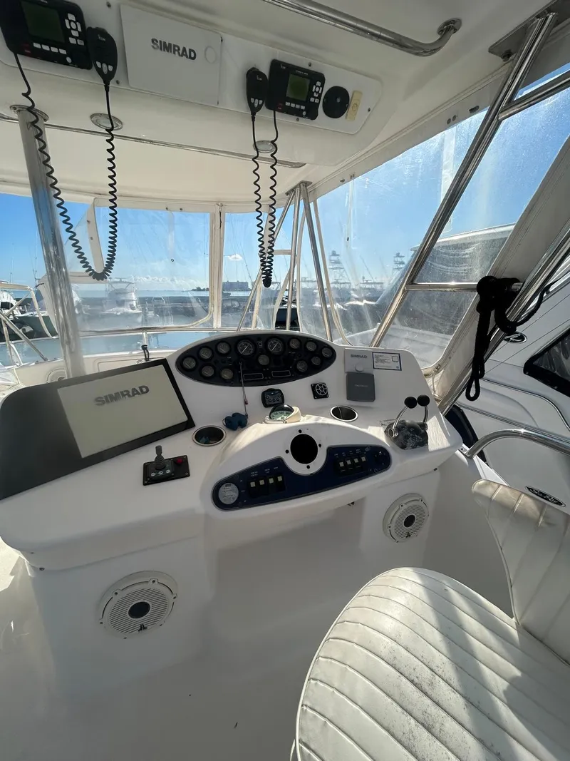 Slide: The Image of Helm of 2004 Riviera 40 yacht with Simrad navigation system and controls. - 15