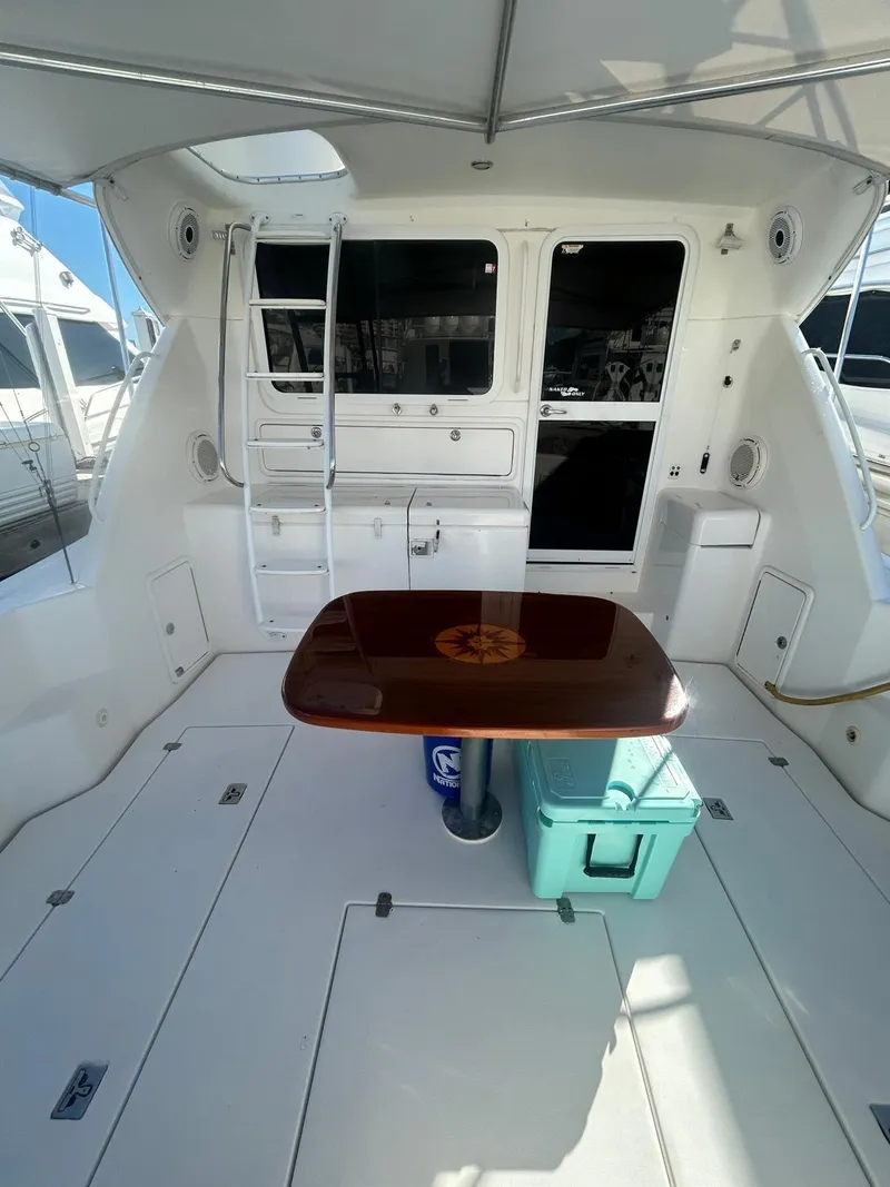 Slide: The Image of 2004 Riviera 40 yacht interior with table, ladder, and storage compartments. - 7