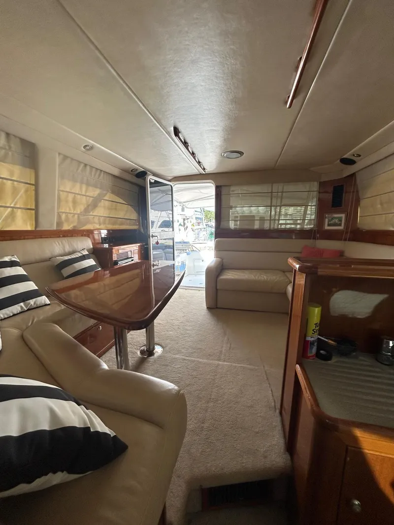 Slide: The Image of Interior of a 2004 Riviera 40 yacht with elegant seating and wooden accents. - 9