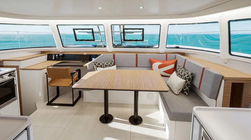 Slide: The Image of Modern interior of 2025 Excess 13 catamaran with panoramic windows and stylish seating area. - 6