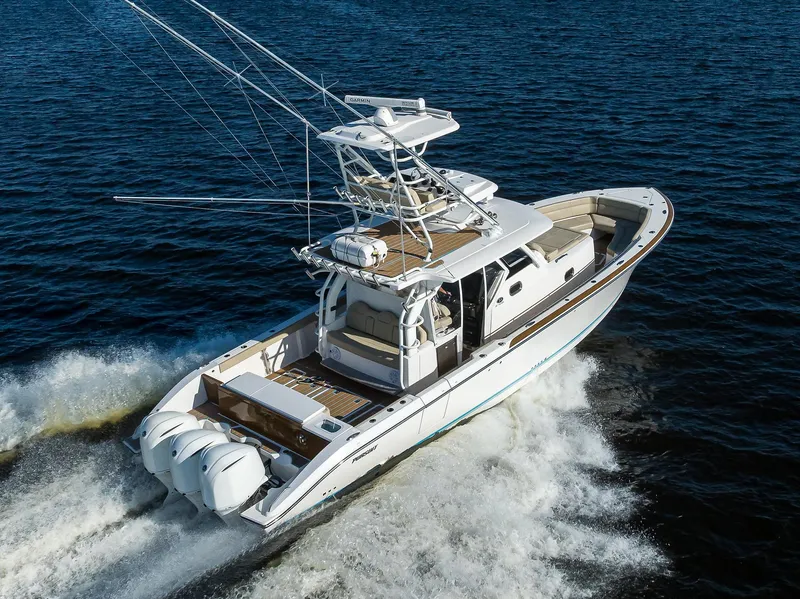 Slide: The Image of 2017 Pursuit S408 boat cruising on open water, showcasing sleek design and powerful engines. - 4