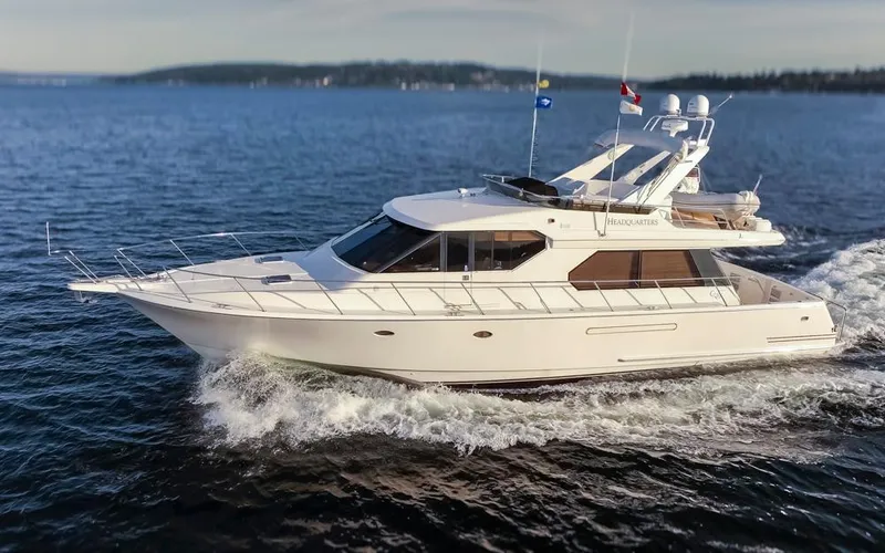 Slide: The Image of 1999 West Bay 58 Pilothouse Motor Yacht cruising on open water. - 1