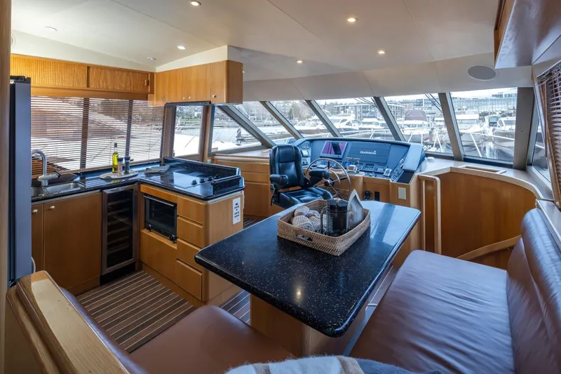 Slide: The Image of 1999 West Bay 58 Pilothouse Motor Yacht interior with kitchen and helm station. - 10