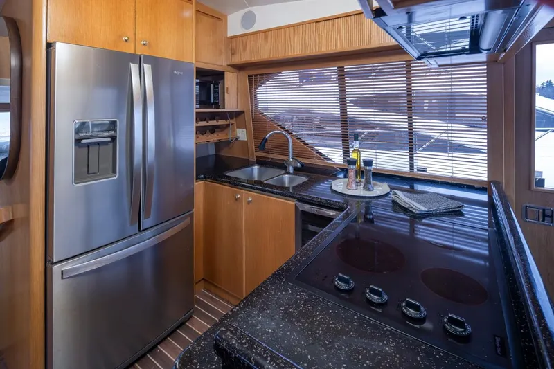 Slide: The Image of Modern kitchen in 1999 West Bay 58 Pilothouse Motor Yacht with stainless steel appliances. - 11