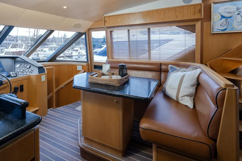 Slide: The Image of Luxurious interior of 1999 West Bay 58 Pilothouse Motor Yacht with leather seating and panoramic windows. - 12
