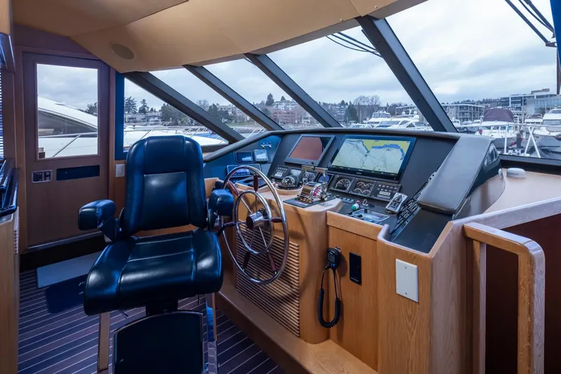 Slide: The Image of Pilothouse interior of 1999 West Bay 58 Motor Yacht with navigation equipment and captain's chair. - 13
