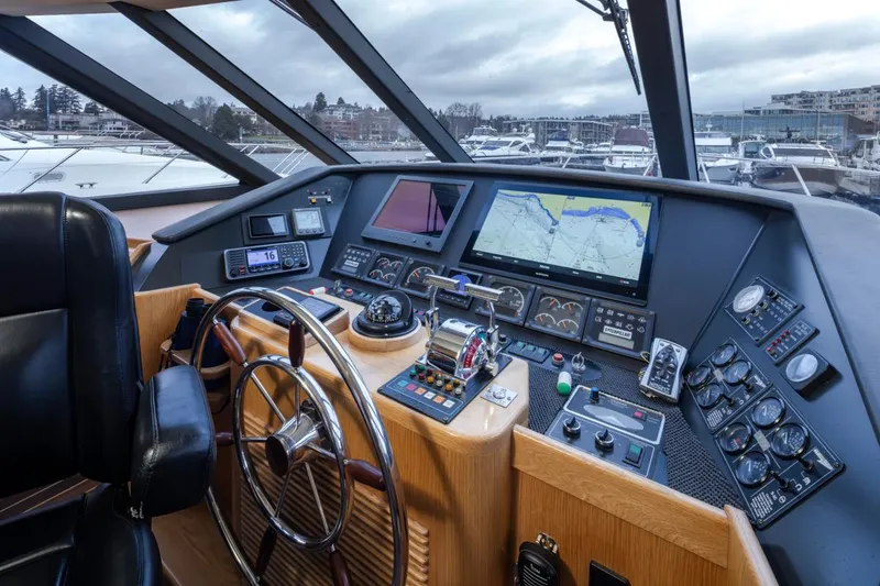 Slide: The Image of 1999 West Bay 58 Pilothouse Motor Yacht helm with navigation screens and controls. - 14